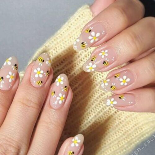 A woman's hands with flower nail designs