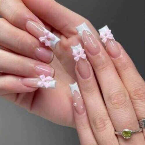 Woman's hands with pink nail designs